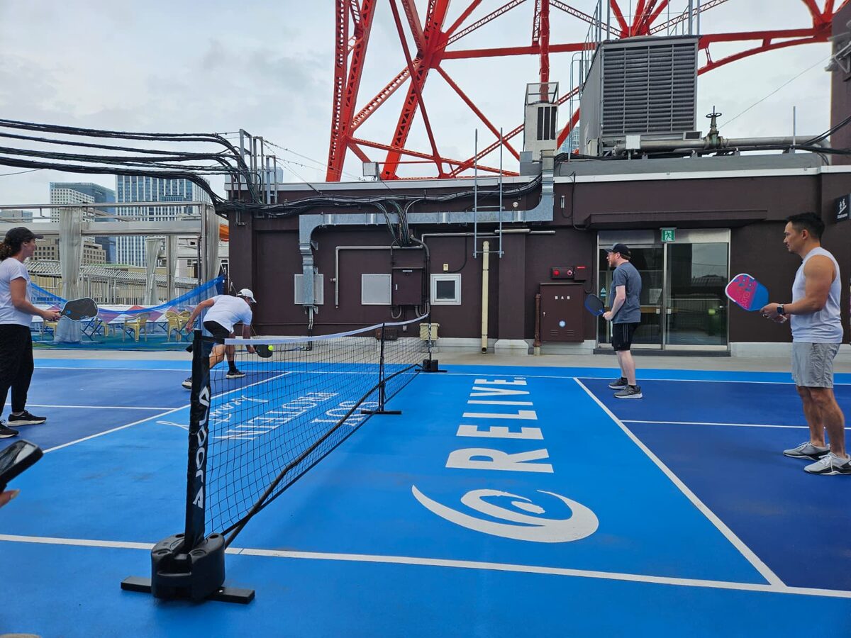 Playing pickleball on a rooftop court beneath Tokyo Tower