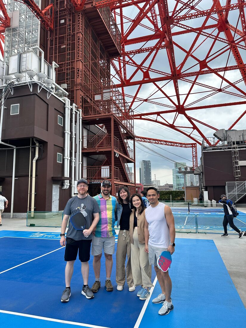 Our group on the rooftop pickleball court under Tokyo Tower